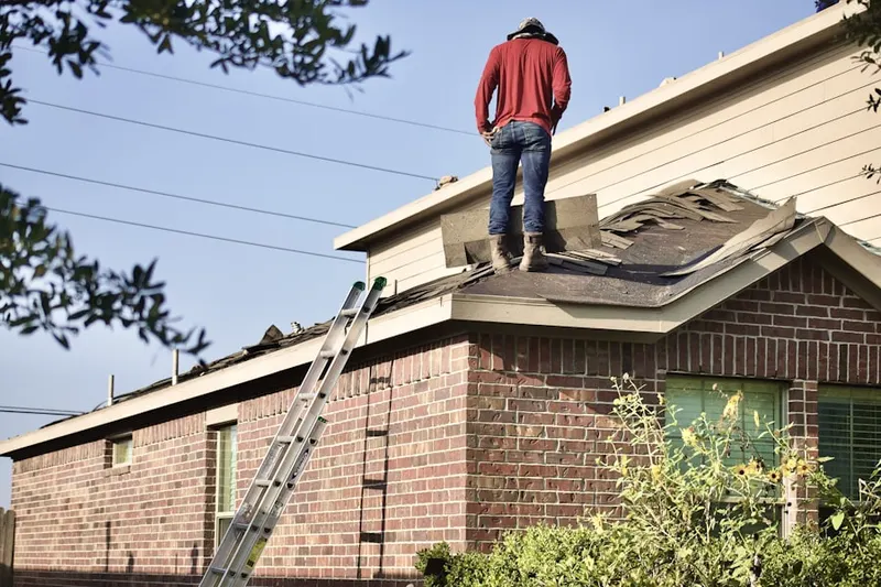 Professional roofer working on a residential roof in O'Brien